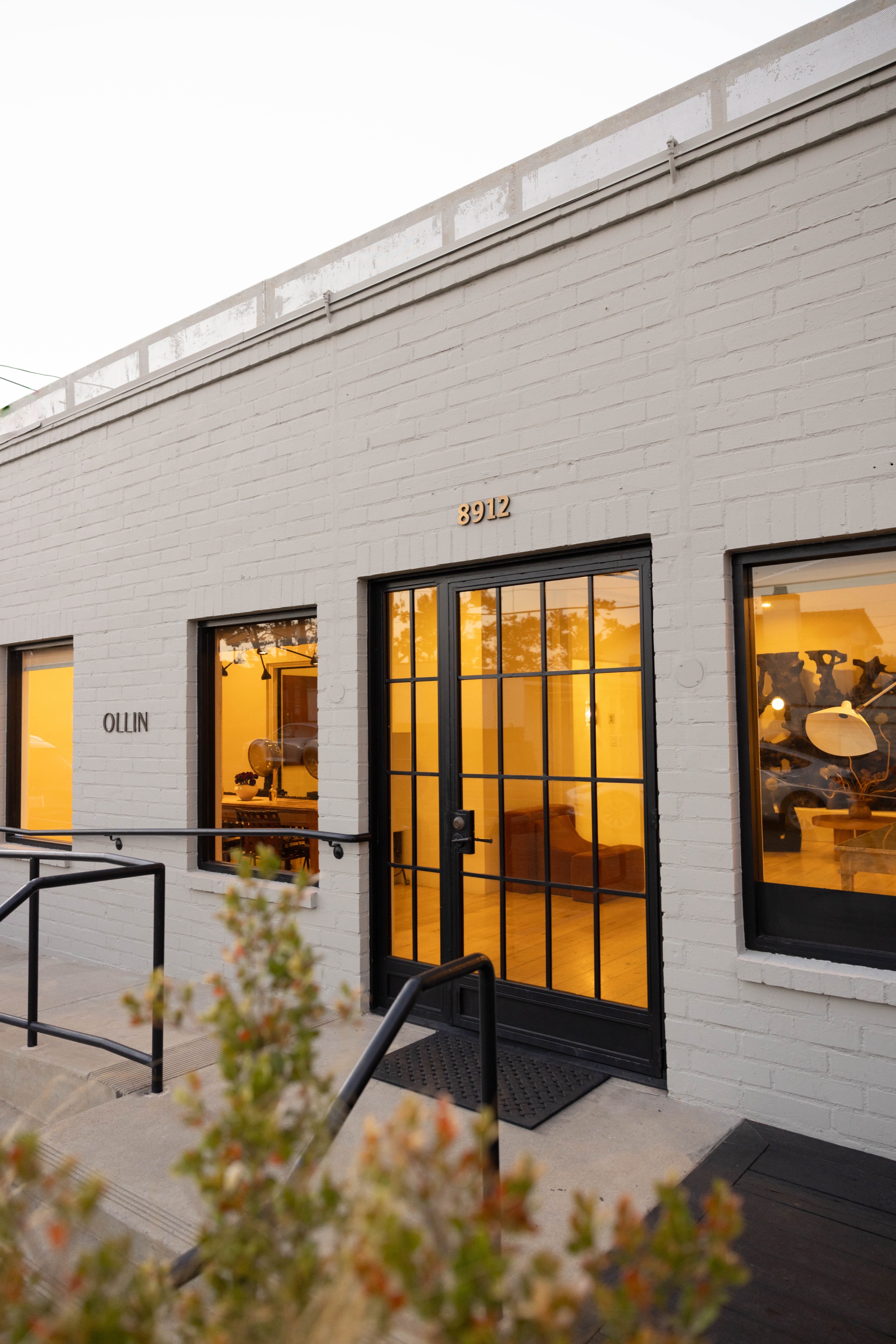 The OLLIN storefront on West Olympic Boulevard in Beverly Hills, its windows warm with light